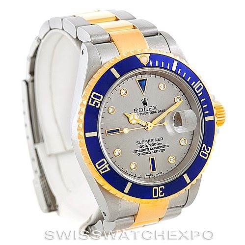 This image displays a Rolex Submariner 16613 Men's Steel and Gold (two tone) Grey Dial 16613 Men's Steel and Gold (two tone) Grey Dial watch from an angle showing the face, bezel, crown, and bracelet.