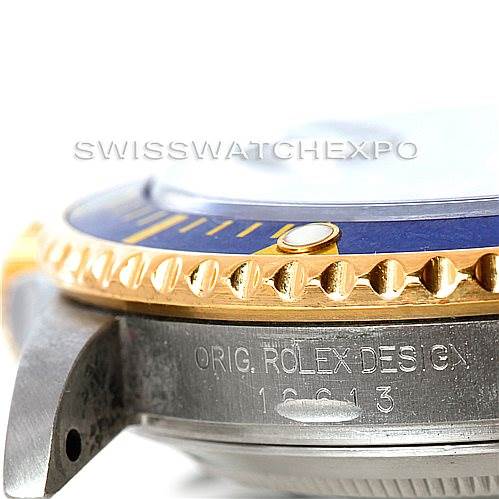 This close-up angle shows the side of a Rolex Submariner 16613 Men
s Steel and Gold (two tone) Blue Dial 16613 Men
s Steel and Gold (two tone) Blue Dial, focusing on its bezel and case with the model number engraved.