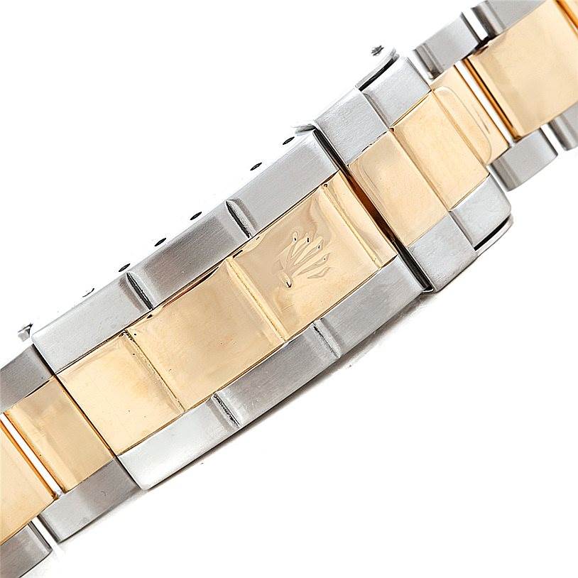 The image shows the bracelet of a Rolex Submariner 16613 Men's Steel and Gold (two tone) Champagne Dial 16613 Men's Steel and Gold (two tone) Champagne Dial, featuring a mix of gold and stainless steel links with the Rolex crown logo.