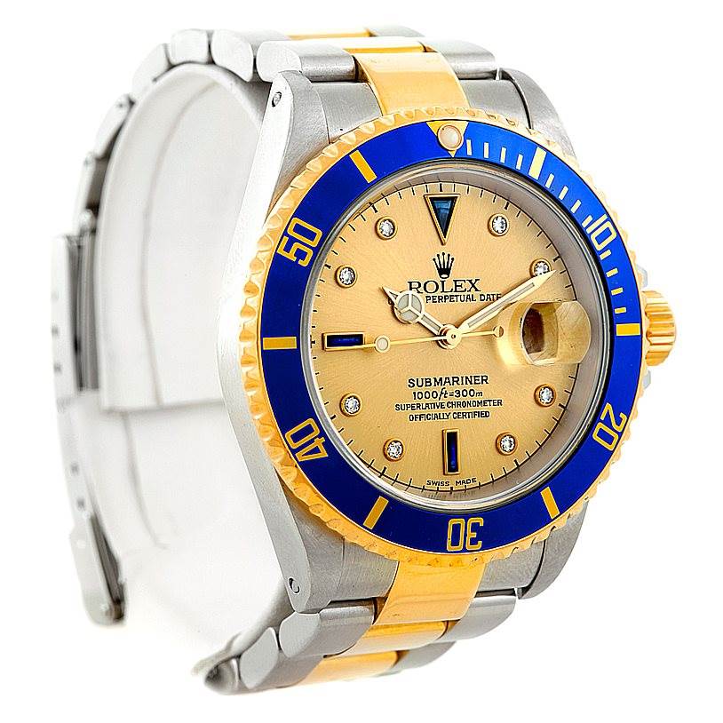 This Rolex Submariner 16613 Men's Steel and Gold (two tone) Champagne Dial 16613 Men's Steel and Gold (two tone) Champagne Dial watch is shown from a front angle, displaying its bezel, dial, hands, and bracelet.