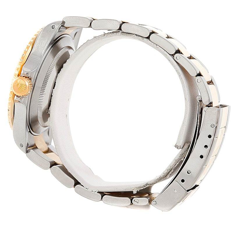 This side view of the Rolex Submariner 16613 Men's Steel and Gold (two tone) Champagne Dial 16613 Men's Steel and Gold (two tone) Champagne Dial shows the case, crown, bezel, and metal bracelet.