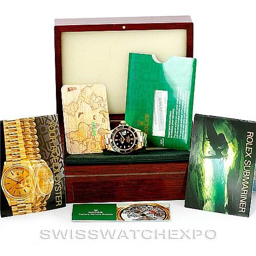The image shows a Rolex Submariner 16618 Men
s Yellow Gold Black Dial 16618 Men
s Yellow Gold Black Dial watch in its box with its accessories, including manuals and Best Quality
ation cards.