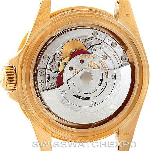 The image shows the back view of a Rolex Submariner 16618 Men
s Yellow Gold Black Dial 16618 Men
s Yellow Gold Black Dial, focusing on its exposed watch movement and internal components.