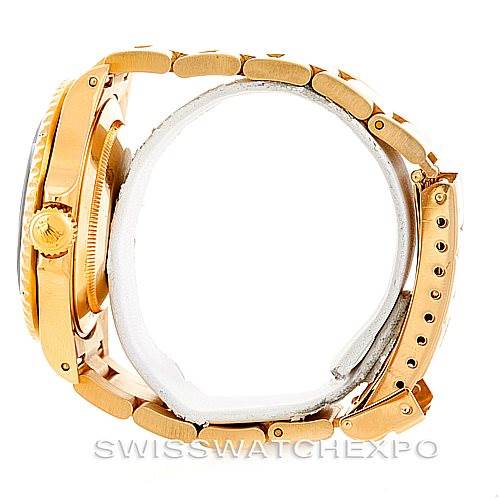 The image shows a side view of a Rolex Submariner 16618 Men
s Yellow Gold Black Dial 16618 Men
s Yellow Gold Black Dial watch, highlighting its crown, case, and bracelet.