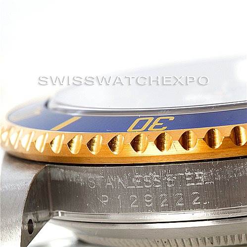 This image shows a close-up side view of the Rolex Submariner 16613 Men's Steel and Gold (two tone) Grey Dial 16613 Men's Steel and Gold (two tone) Grey Dial's bezel and part of its stainless steel case with engraved details.