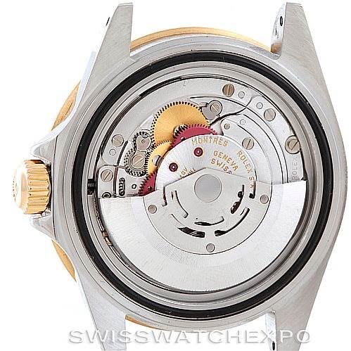 The image shows the back of the Rolex Submariner 16613 Men's Steel and Gold (two tone) Grey Dial 16613 Men's Steel and Gold (two tone) Grey Dial watch, highlighting the internal movement and mechanical components.