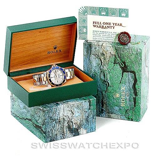 The Rolex Submariner 16613 Men's Steel and Gold (two tone) Grey Dial 16613 Men's Steel and Gold (two tone) Grey Dial watch is shown in its open green and wooden box, alongside its outer box and warranty card.