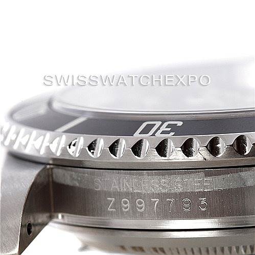 This image shows a close-up side view of a Rolex Submariner 16610 Men
s Stainless Steel Black Dial 16610 Men
s Stainless Steel Black Dial watch, focusing on the bezel and part of the case with the serial number visible.