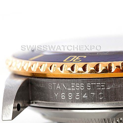 This image shows a close-up side angle of a Rolex Submariner 16613 Men's Steel and Gold (two tone) Champagne Dial 16613 Men's Steel and Gold (two tone) Champagne Dial, highlighting the bezel and serial number on the stainless steel case.