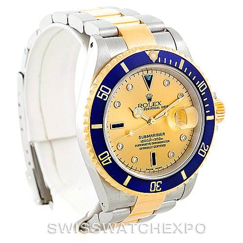 This Rolex Submariner 16613 Men's Steel and Gold (two tone) Champagne Dial 16613 Men's Steel and Gold (two tone) Champagne Dial watch is shown at an angle displaying the dial, bezel, case, and part of the bracelet.