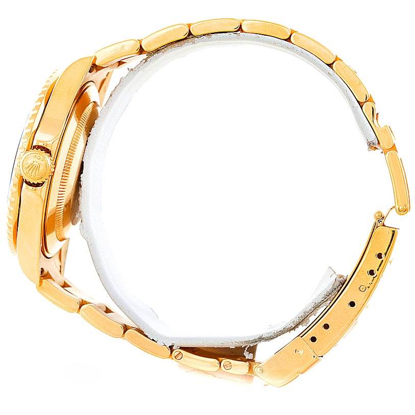 The image shows a side view of a Rolex Submariner 16618 Men
s Yellow Gold Black Dial 16618 Men
s Yellow Gold Black Dial watch, highlighting its case, crown, and bracelet.