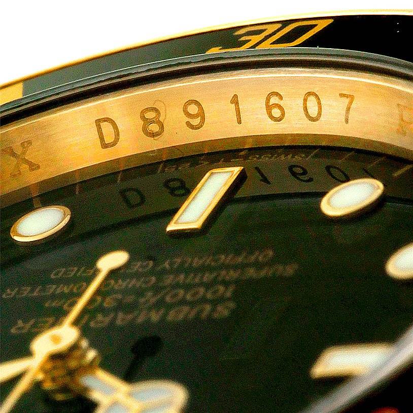 The image shows a close-up angle of the dial, hands, and a portion of the bezel of a Rolex Submariner 16618 Men
s Yellow Gold Black Dial 16618 Men
s Yellow Gold Black Dial, focusing on the serial number.