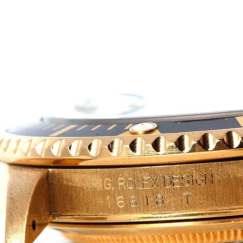 The image shows the side view of a Rolex Submariner 16618 Men
s Yellow Gold Black Dial 16618 Men
s Yellow Gold Black Dial watch, highlighting the bezel and engraved case side.