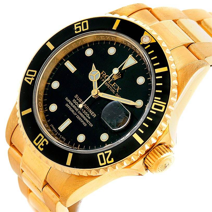 The image shows a Rolex Submariner 16618 Men
s Yellow Gold Black Dial 16618 Men
s Yellow Gold Black Dial watch at a tilted angle highlighting the face, bezel, crown, and part of the bracelet.