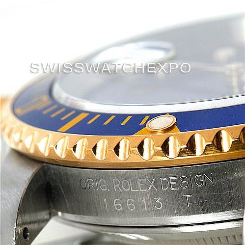 This image shows a close-up of the side of the Rolex Submariner 16613 Men's Steel and Gold (two tone) Blue Dial 16613 Men's Steel and Gold (two tone) Blue Dial watch, highlighting the bezel, crystal, and branding on the side.