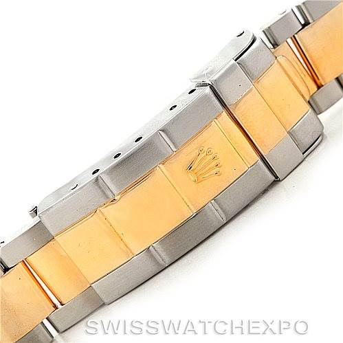 The image shows a close-up of the clasp and bracelet of a Rolex Submariner 16613 Men's Steel and Gold (two tone) Blue Dial 16613 Men's Steel and Gold (two tone) Blue Dial, featuring a two-tone metal design with gold and silver links.