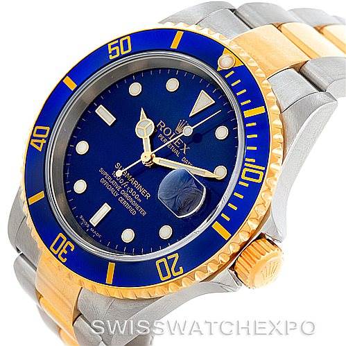 The image shows a Rolex Submariner 16613 Men's Steel and Gold (two tone) Blue Dial 16613 Men's Steel and Gold (two tone) Blue Dial watch, featuring a blue dial and bezel, two-tone strap, and magnified date window at an angle.