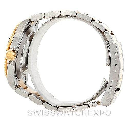 This side-view image of the Rolex Submariner 16613 Men's Steel and Gold (two tone) Blue Dial 16613 Men's Steel and Gold (two tone) Blue Dial watch showcases its bracelet, case, and crown.