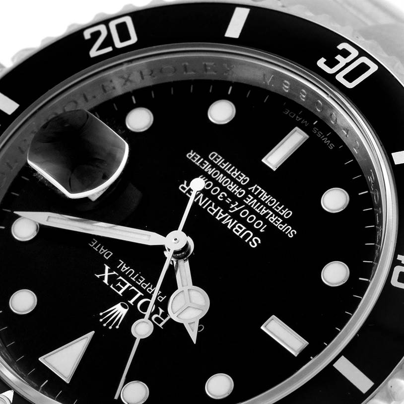 The image shows a close-up of the Rolex Submariner 16610 Men
s Stainless Steel Black Dial 16610 Men
s Stainless Steel Black Dial
s dial and bezel at an angle, highlighting the date magnifier and luminescent markers.