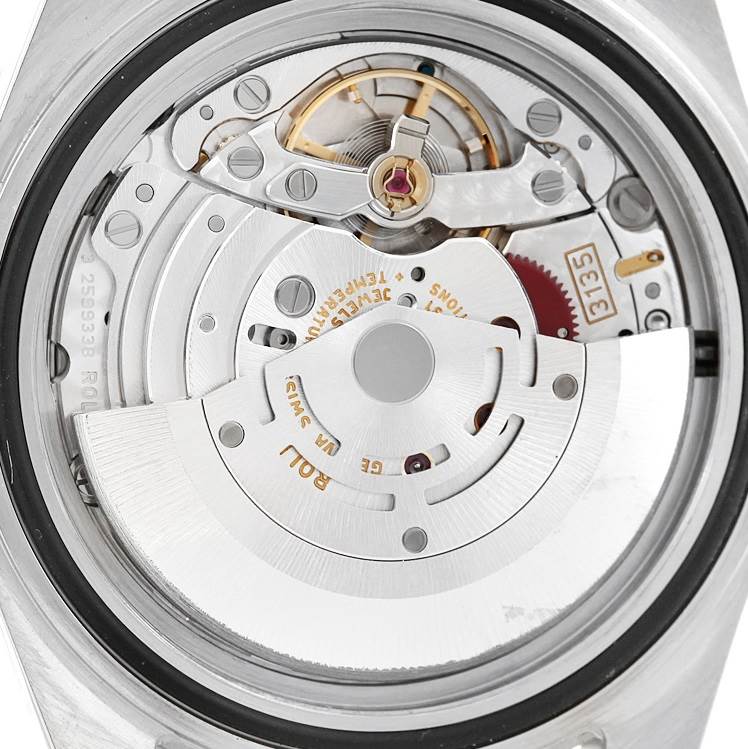 This image shows the movement mechanism of a Rolex Submariner 16610 Men
s Stainless Steel Black Dial 16610 Men
s Stainless Steel Black Dial watch from the back angle, detailing the oscillating weight and gears.