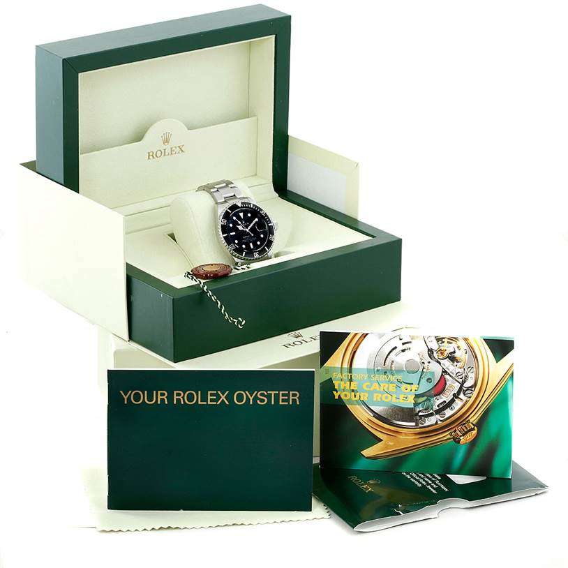 The image shows a Rolex Submariner 16610 Men
s Stainless Steel Black Dial 16610 Men
s Stainless Steel Black Dial watch in its presentation box, along with manuals and a warranty card.