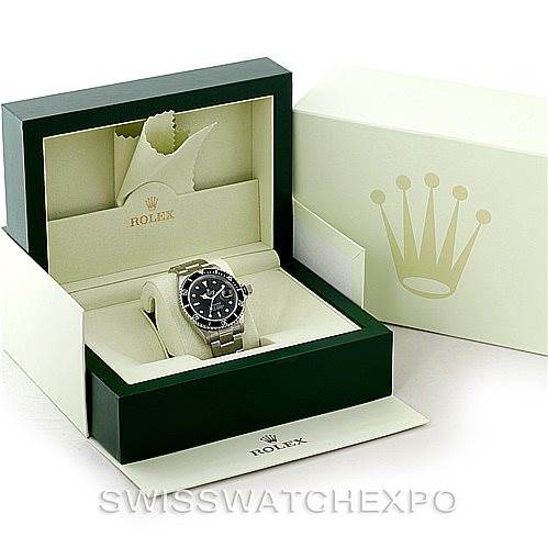 The image shows a Rolex Submariner 16610 Men
s Stainless Steel Black Dial 16610 Men
s Stainless Steel Black Dial watch from a front angle, displayed in its green box with branding elements and a warranty card.