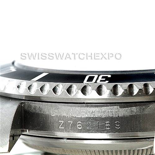This image shows a close-up side view of the bezel and case of a Rolex Submariner 16610 Men
s Stainless Steel Black Dial 16610 Men
s Stainless Steel Black Dial watch, displaying part of the serial number.