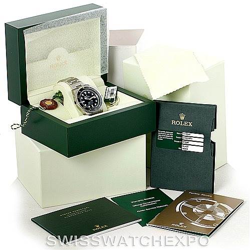 The image shows a Rolex Submariner 114060 Men
s Stainless Steel Black Dial 114060 Men
s Stainless Steel Black Dial watch at a front angle, with its box, booklets, tags, and additional packaging.