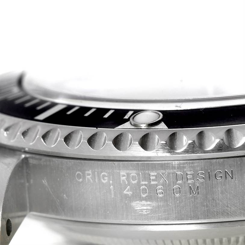 This image shows a close-up, side view of the bezel and case of a Rolex Submariner 14060 Men
s Stainless Steel Black Dial 14060 Men
s Stainless Steel Black Dial watch, revealing the engraved model number "14060M".