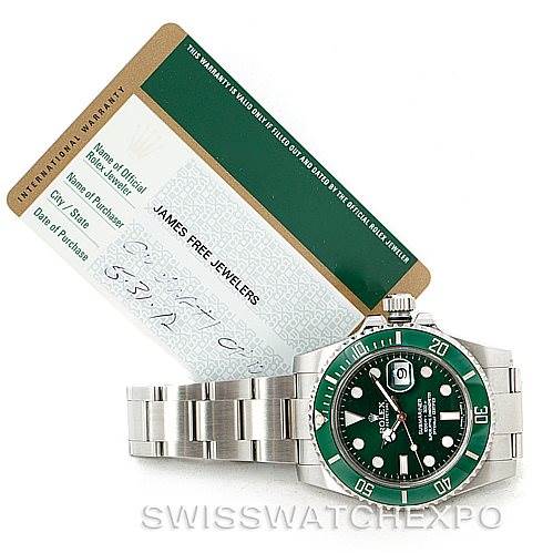 The image shows a Rolex Submariner 116610LV Men's Stainless Steel Green Dial 116610LV Men's Stainless Steel Green Dial watch facing up with its band partially spread out and an international warranty card behind it.