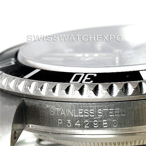 The image shows a close-up of the side and bezel of a Rolex Submariner 16610 Men
s Stainless Steel Black Dial 16610 Men
s Stainless Steel Black Dial watch, focusing on the stainless steel engraving and model number.