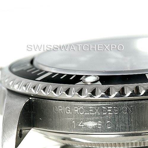 Close-up of a Rolex Submariner 14060 Men
s Stainless Steel Black Dial 14060 Men
s Stainless Steel Black Dial watch showing the bezel, part of the face, and the case engraving.