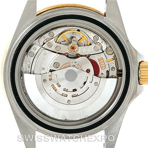 This image shows the backside of a Rolex Submariner 16613 Men's Steel and Gold (two tone) Blue Dial 16613 Men's Steel and Gold (two tone) Blue Dial watch, featuring its internal movement mechanism.