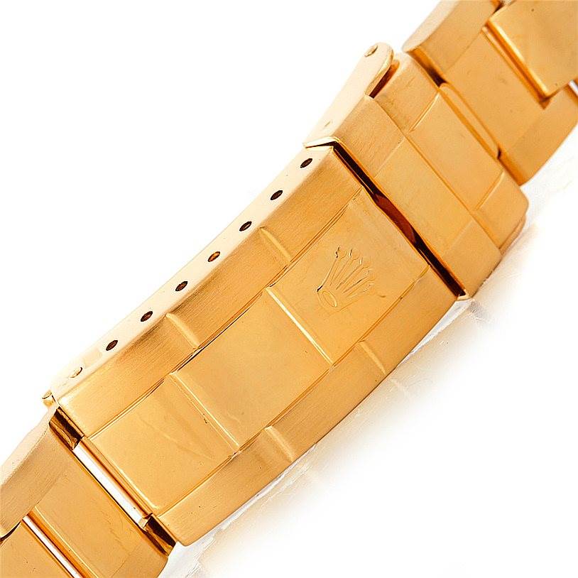 This image shows a close-up of the gold bracelet clasp of a Rolex Submariner 16618 Men
s Yellow Gold Blue Dial 16618 Men
s Yellow Gold Blue Dial watch at an angled view.