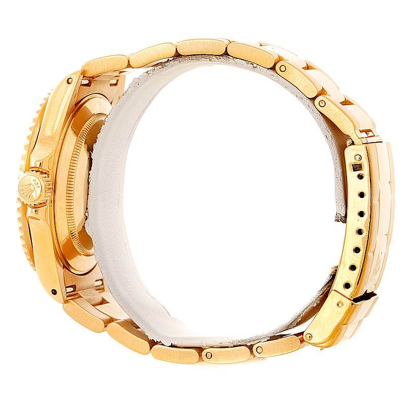 This image shows the side view of a Rolex Submariner 16618 Men
s Yellow Gold Blue Dial 16618 Men
s Yellow Gold Blue Dial watch, specifically highlighting the crown, case, and bracelet links.