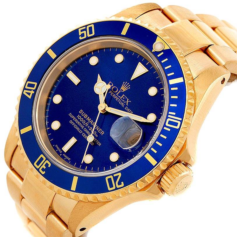 The image shows a Rolex Submariner 16618 Men
s Yellow Gold Blue Dial 16618 Men
s Yellow Gold Blue Dial watch angled to display the dial, bezel, crown, and part of the bracelet.