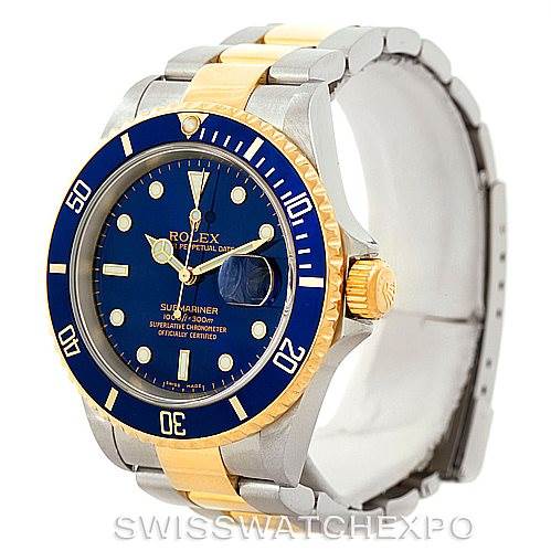 The image displays a Rolex Submariner 16613 Men
s Steel and Gold (two tone) Blue Dial 16613 Men
s Steel and Gold (two tone) Blue Dial watch from an angled front view, highlighting its blue dial, bezel, and two-tone bracelet.