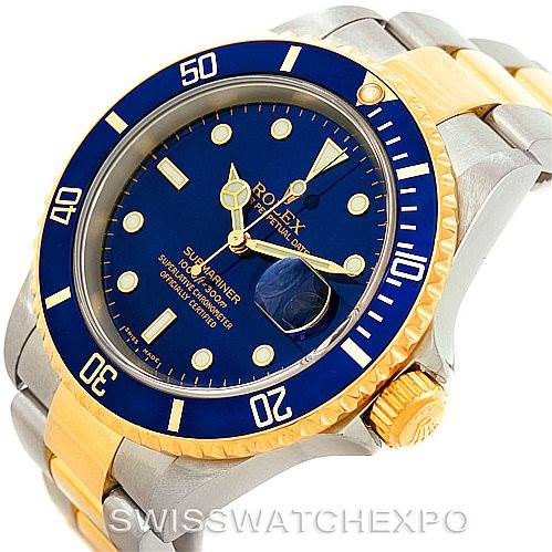 This image shows a Rolex Submariner 16613 Men
s Steel and Gold (two tone) Blue Dial 16613 Men
s Steel and Gold (two tone) Blue Dial watch from an angled perspective, highlighting its blue dial, date display, and two-tone bracelet.