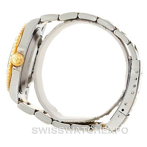 The image shows a side view of a Rolex Submariner 16613 Men
s Steel and Gold (two tone) Blue Dial 16613 Men
s Steel and Gold (two tone) Blue Dial watch, highlighting its crown, case, and part of the bracelet.