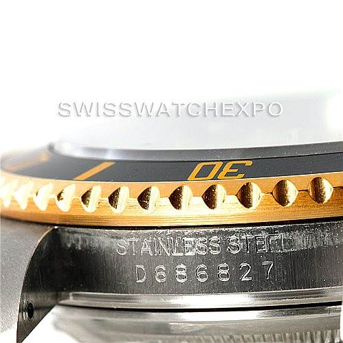 The image shows a close-up side view of the bezel and case of a Rolex Submariner 16613 Men's Steel and Gold (two tone) Champagne Dial 16613 Men's Steel and Gold (two tone) Champagne Dial watch, highlighting the serial number and bezel edge.