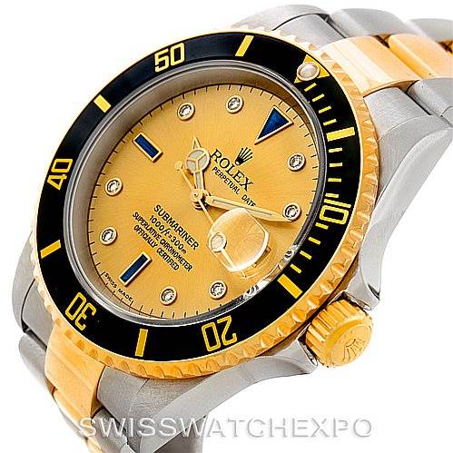 This image shows a Rolex Submariner 16613 Men's Steel and Gold (two tone) Champagne Dial 16613 Men's Steel and Gold (two tone) Champagne Dial watch from an angled top view, displaying the dial, bezel, crown, and bracelet.