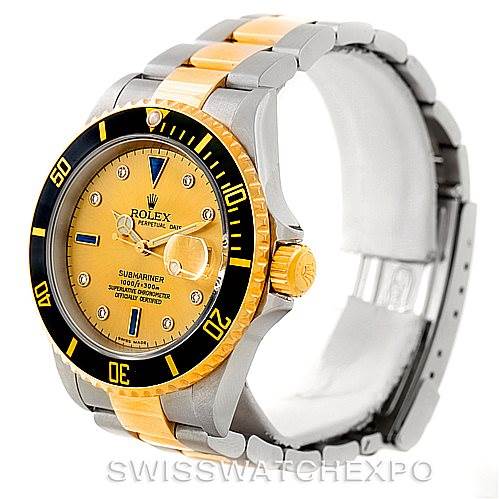 The image shows a Rolex Submariner 16613 Men's Steel and Gold (two tone) Champagne Dial 16613 Men's Steel and Gold (two tone) Champagne Dial watch from a three-quarter angle, highlighting its bezel, dial, and bracelet.