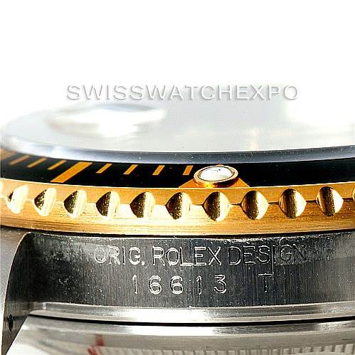 This image shows a close-up of the side of a Rolex Submariner 16613 Men's Steel and Gold (two tone) Champagne Dial 16613 Men's Steel and Gold (two tone) Champagne Dial watch, focusing on the bezel and case with the model number 16613 engraved.