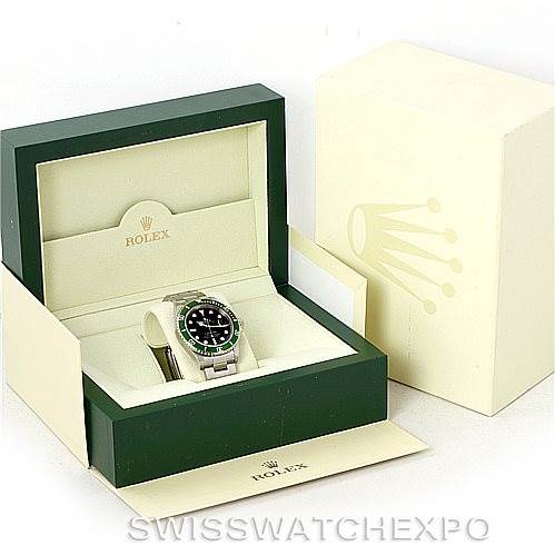 The image shows a Rolex Submariner 16610V Men
s Stainless Steel Black Dial 16610V Men
s Stainless Steel Black Dial watch in an open green and cream box with the watch facing forward.