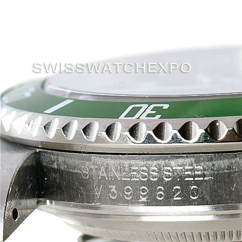 The image shows a close-up side view of the Rolex Submariner 16610V Men
s Stainless Steel Black Dial 16610V Men
s Stainless Steel Black Dial, highlighting the bezel, part of the crown, and the engraved serial number.