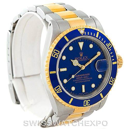 The image shows a Rolex Submariner 16613 Men's Steel and Gold (two tone) Blue Dial 16613 Men's Steel and Gold (two tone) Blue Dial watch at an angled view, highlighting its blue dial, bezel, and dual-tone bracelet.