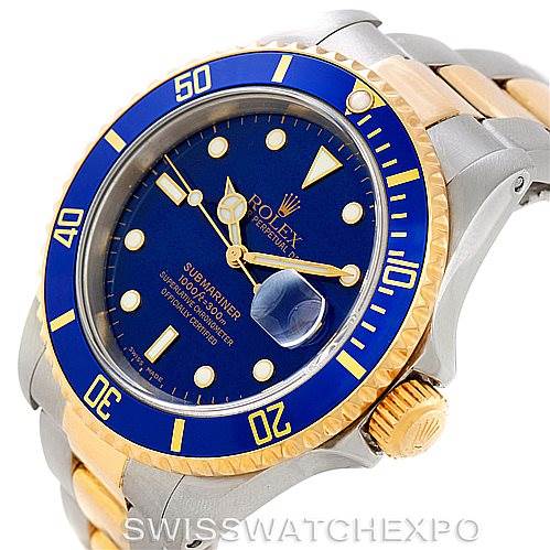 The image showcases a Rolex Submariner 16613 Men's Steel and Gold (two tone) Blue Dial 16613 Men's Steel and Gold (two tone) Blue Dial watch at a slight angle, featuring its blue dial, bezel, and two-tone steel and gold bracelet.