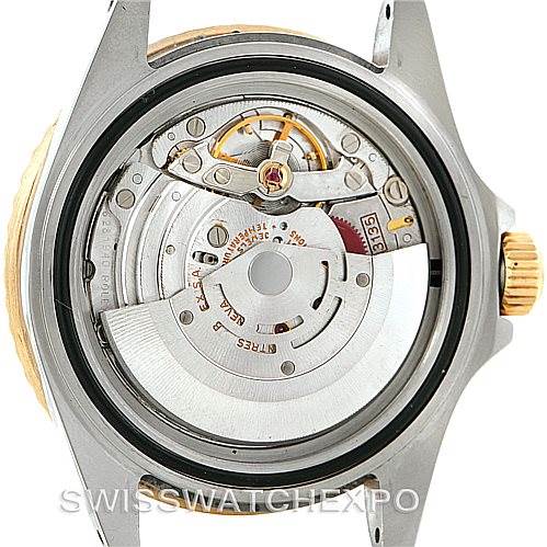 This image shows the open case back of a Rolex Submariner 16613 Men's Steel and Gold (two tone) Blue Dial 16613 Men's Steel and Gold (two tone) Blue Dial, revealing its intricate inner movement mechanism.