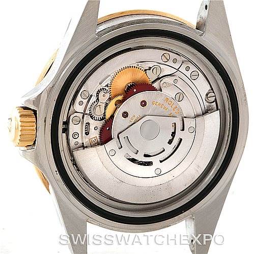 This image shows the movement and internal mechanism of a Rolex Submariner 16613 Men's Steel and Gold (two tone) Grey Dial 16613 Men's Steel and Gold (two tone) Grey Dial watch from a rear angle.