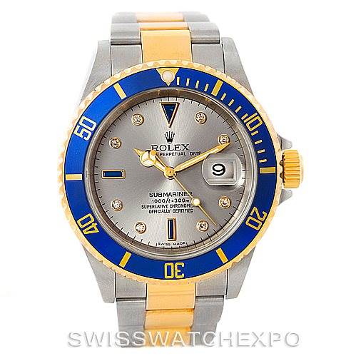 This image shows a Rolex Submariner 16613 Men's Steel and Gold (two tone) Grey Dial 16613 Men's Steel and Gold (two tone) Grey Dial watch from a front angle, highlighting its blue and gold bezel, dial, and two-tone bracelet.